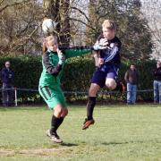 Cumnor’s Dominic Taylor rises to pop the ball over the head of Grove Challengers’ goalkeeper Ally Paton