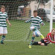 Didcot’s Nathan Sandland clears the ball during his side’s Under 12 Spring A League clash with Summertown