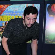 Actor Ralph Little tries his hand at table football at the premiere of The Unbeatables
