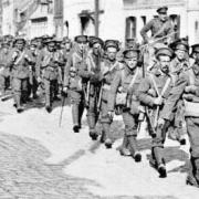 BEF troops march through a village in northern France