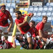 London Welsh debutant Piri Weepu looks to get the ball away before being tackled by Exeter’s two-try No 8 Thomas Waldrom during his side’s 52-0 defeat at the Kassam Stadium. Picture: Andy Fitzpatrick