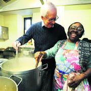 Andrew Bax helps Icolyn Smith prepare food at the soup kitchen