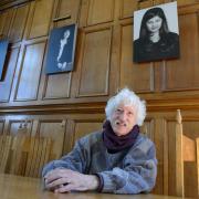 Ringing the changes: Bill Heine at Hertford College, 40 years after it allowed female students. On the wall behind are the images of women, left to right, Charlotte Hogg, banker, Theresa Moran, teacher, and Shahnaz Ahsan, scholar