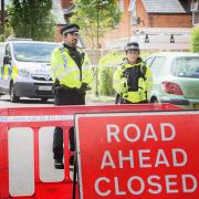 Guard: Police remained on the cordons in Vicarage Road, Didcot, yesterday