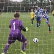 Headington Under 12s keeper Aiden Jackson saves a penalty from St Edmunds' Josh Richardson in his side's 19-0 defeat