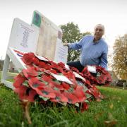 Keith Brooks with his own wooden war memorial on the village green in Horspath that the parish council said should be removed