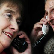 Friendly voice: John Ogle has weekly phone chats with Phone Friend volunteer Mary Wood