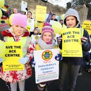Campaign: Lizzie Motley and Honour Nolan, both four, and Sandy Motley, seven, join the demonstration outside Ace Children’s Centre in Chipping Norton last month