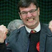 Labour's Duncan Enright celebrates holding his Witney East seat at the count at the Windrush Leisure Centre in Witney