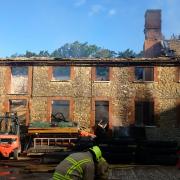 The blackened furniture workshop in Coleshill that was gripped by fire this morning