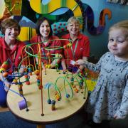 Oxford Children's Hospital is 10-years-old this year. .Three-year-old Maiya Clarke in the outpatients department with, L to R, senior health play specialists Sonia Dugmore and Becky Clifford, and health play specialist Sheila