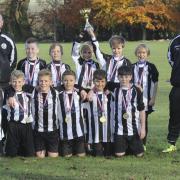 SILVERWARE: Grove Challengers White celebrate after winning the Oxford Mail Youth League Under 11 Supplementary Cup. The team who are sponsored by PR Building Services, beat Headington 6-2 in the final. The team, pictured with coaches Tony Reed and Jason