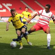 Todd Kane (left) gets forward for Oxford United at Doncaster Rovers  Picture: James Williamson