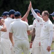 SUPER SHOW: Neil Smith (right) gets a high five after trapping Max Mannering lbw  Pictures: Ric Mellis