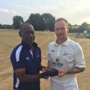 FINE DISPLAY: Gareth Andrew, who finished with match figures of 14-107 against Dorset, receives his county cap from Oxfordshire head coach Rupert Evans Picture: Nick Pinhol