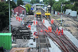 Sparks fly as a rail is cut during installation of a new crossover at Moreton-in-Marsh station in Gloucestershire on Wednesday, August 10, 2011.