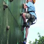 Jamie powers his way up the abseiling wall, while Daniel looks on