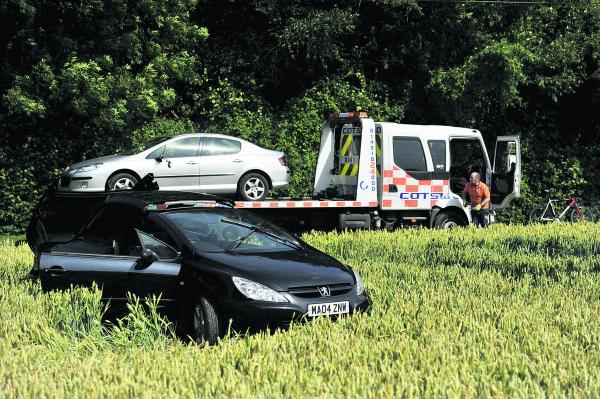 Oxford Mail: Jeremy Clarkson’s black damaged Peugeot and James May’s silver Peugeot on the back of a recovery truck after being pulled out of a ditch  Pictures: Mark Hemsworth