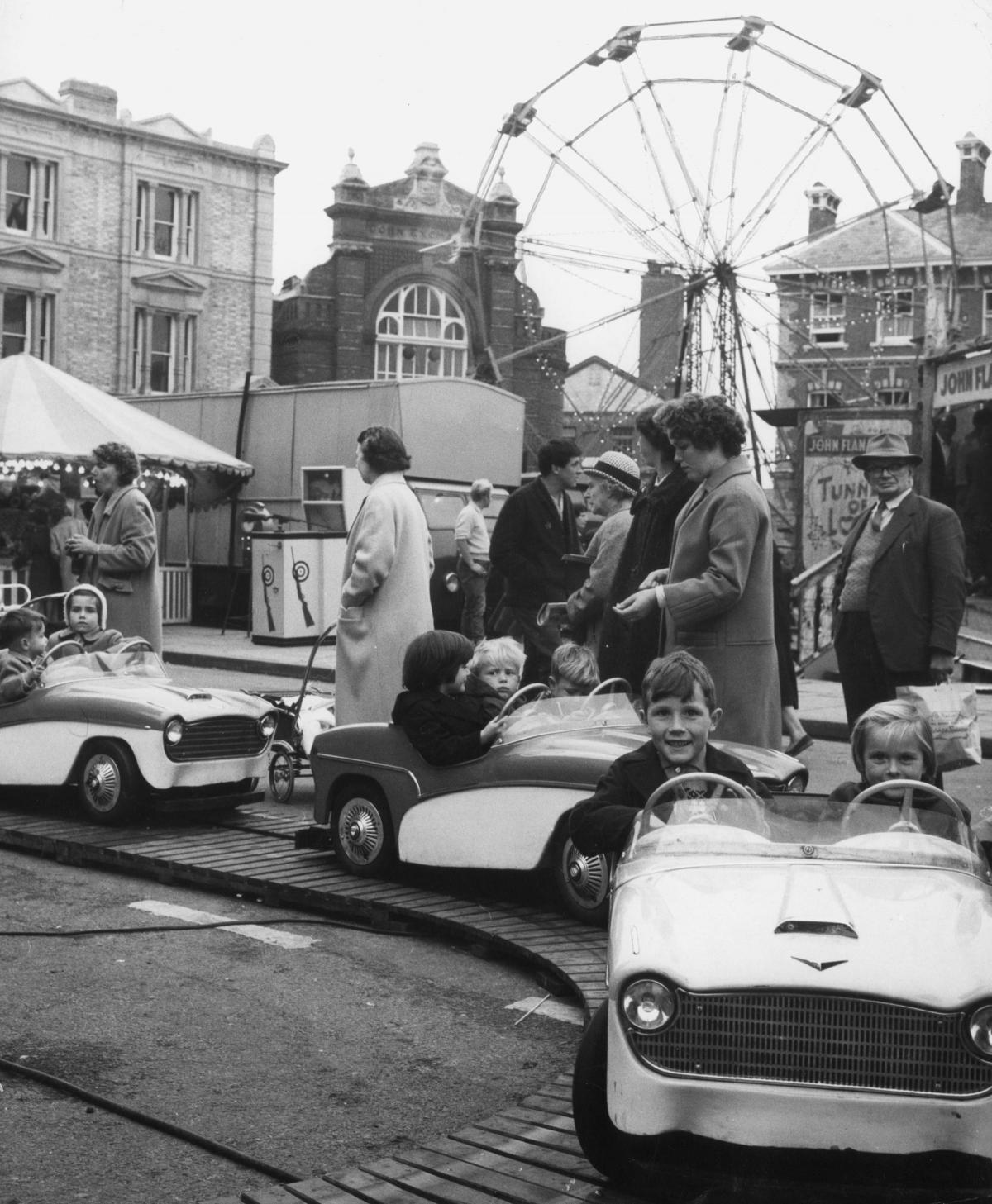 Children try their hand at driving at the Abingdon town fair in 1963.