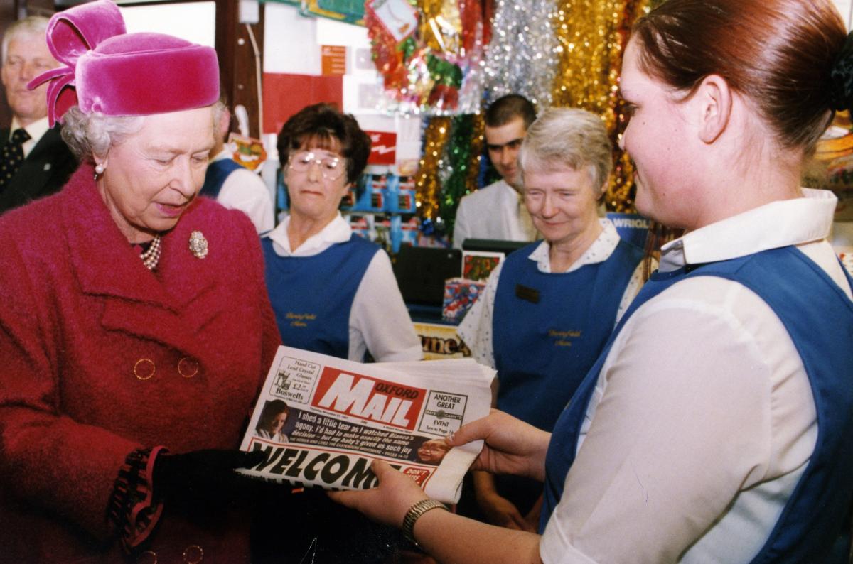 Shop assistant Louise Marshall presents the Queen with a copy of the Oxford Mail during a visit to Berinsfield in November 1997.