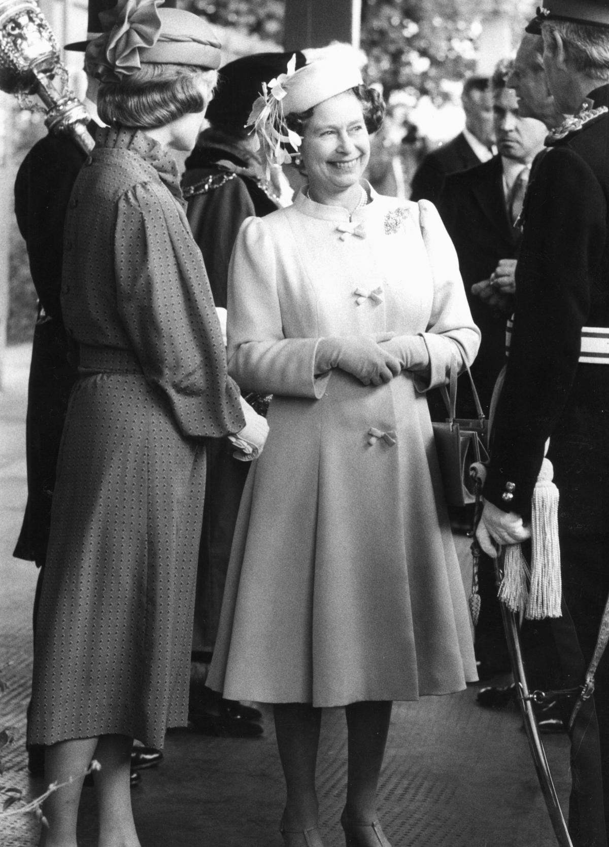 The Queen with guests at the Rhodes House garden party during her visit to Oxford on June 28, 1983.