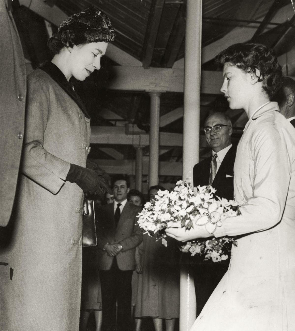 The Queen receives a Bouquet from 15 year old Mollie Lambourne, the youngest weaver, during her vist to Early's blanket mill in April 1959.