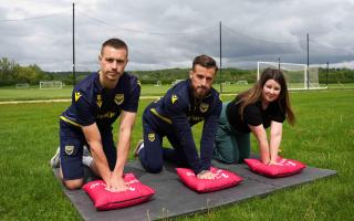 Oxford United players Billy Boden (left) and Joe Bennett (right) learning CPR