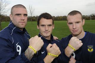 FROM LEFT: United’s Mark Creighton, Jamie Cook and James Constable with their 12th Man wristbands