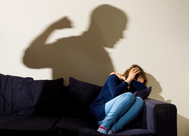 PICTURE POSED BY MODEL File photo dated 09/03/15 of a shadow of a man with a clenched fist as a woman cowers in the corner. A two-session counselling programme for low-level, first time domestic abusers can cut re-offending rates by a third, a groundbreak