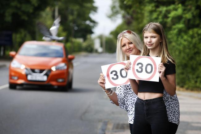 Madi Dingle and mum Nichola stand at the site where Madi was hit by a car on Cumnor Hill last year. Nichola and the parish council have long been campaigning for a reduced speed limit and the county council have just launched a consultation into reducing