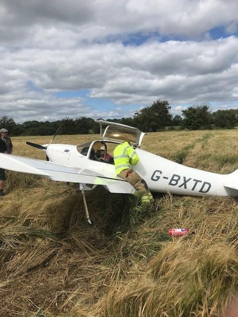 Emergency services with the light aircraft after its emergency landing. Picture: Oxfordshire Fire and Rescue Service