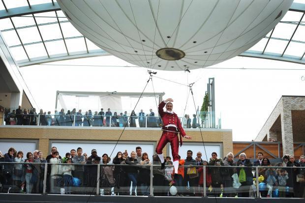 An acrobat entertains shoppers on the first day of the new Westgate Centre