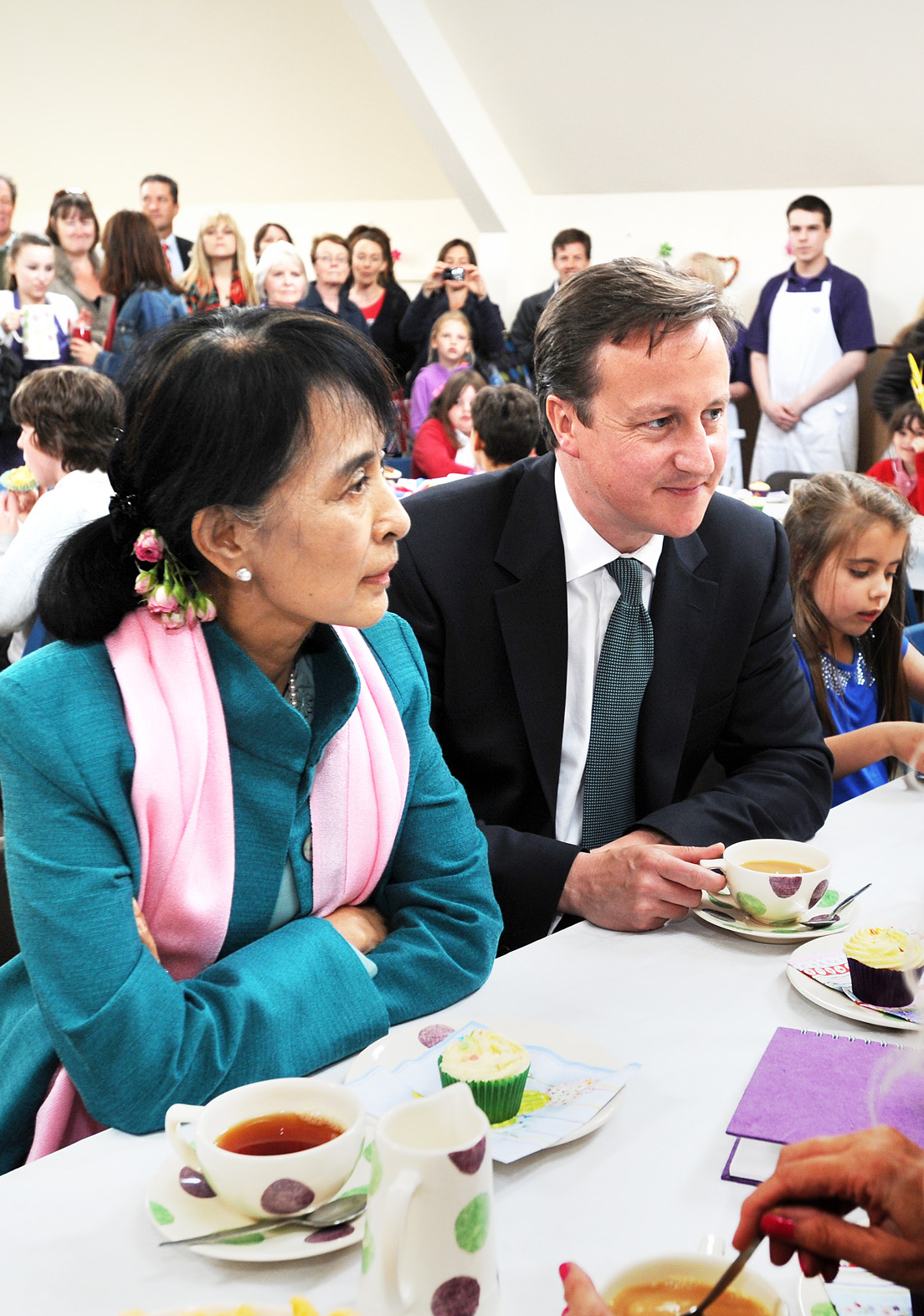Aung San Suu Kyi enjoying a tea party with Prime Minister David Cameron and local children at Aston Pottery. Picture by Jon Lewis