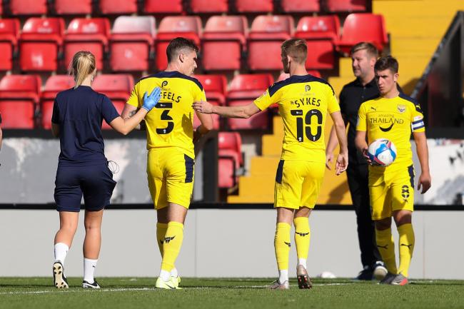 Oxford United's Josh Ruffels is helped from the pitch at Lincoln City on Saturday   Picture: James Williamson