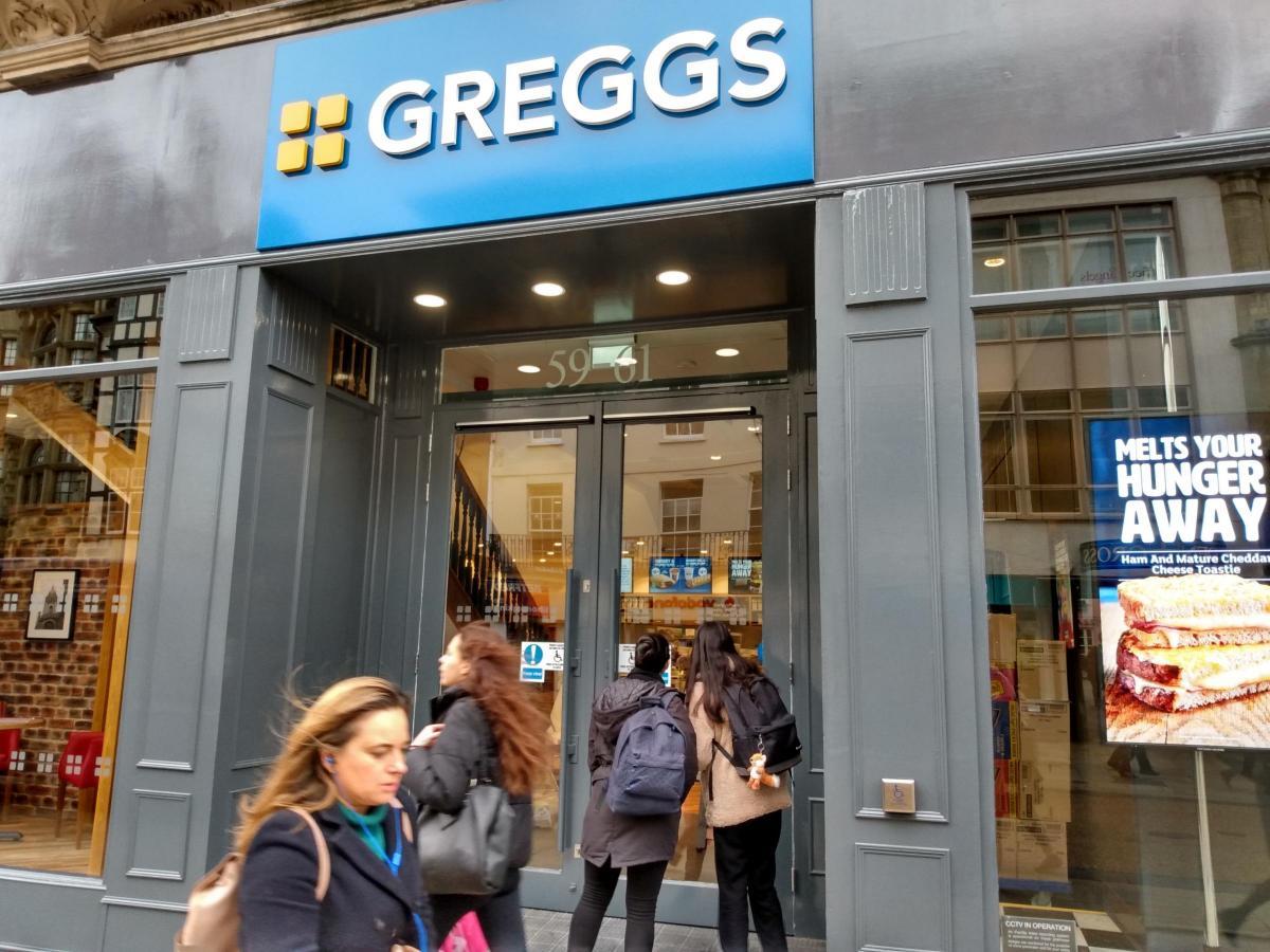 Shoppers walk past Greggs in Cornmarket in 2020