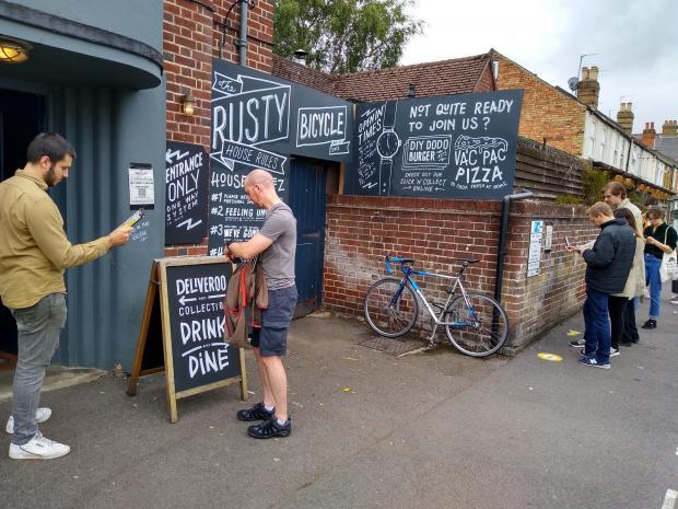 Drinkers queue up outside The Rusty Bicycle 