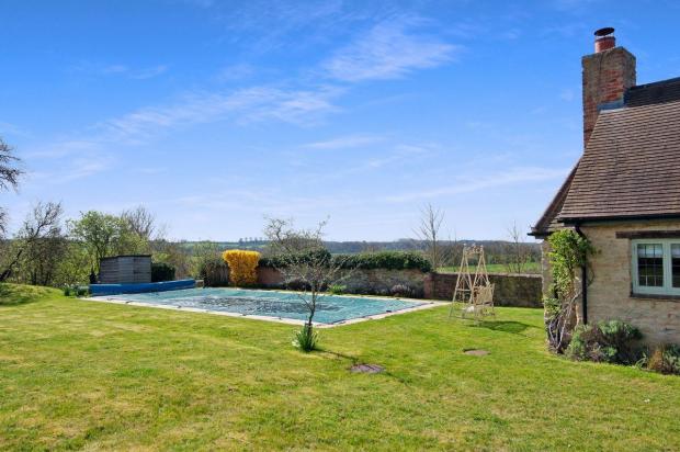 Oxford Mail: The property boasts an outdoor swimming pool. Picture: Strutt & Parker
