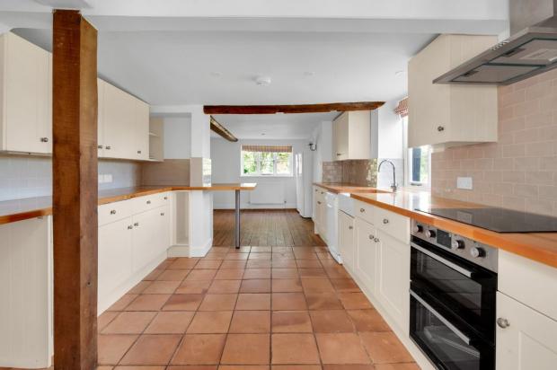 Oxford Mail: The kitchen of the south Oxfordshire cottage. Picture: Strutt & Parker