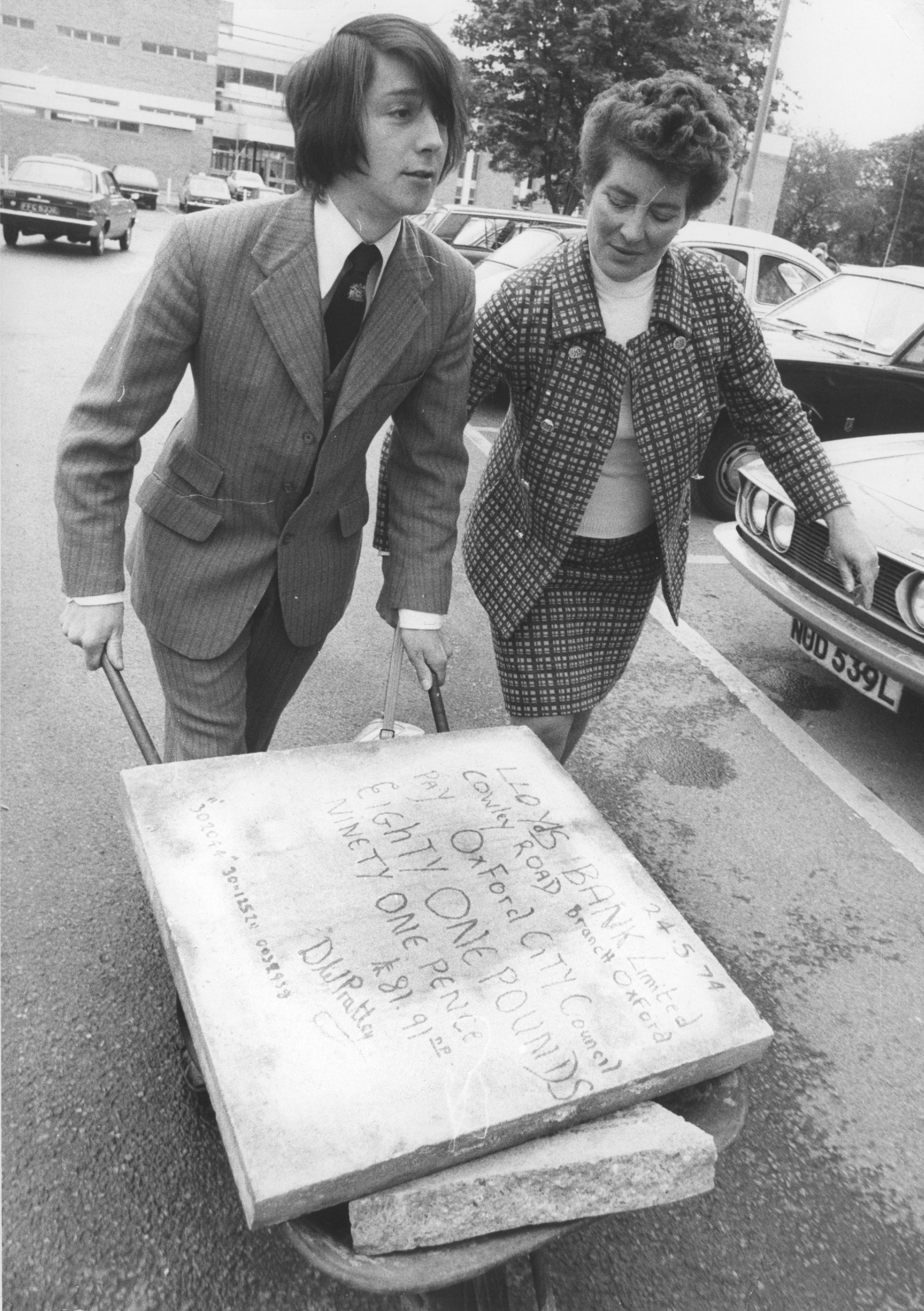 In 1974 councillors Margaret Butler and Dennis Pratley delivered a paing stone cheque to the bank to protest against the cost of paving work in Cornmarket Street