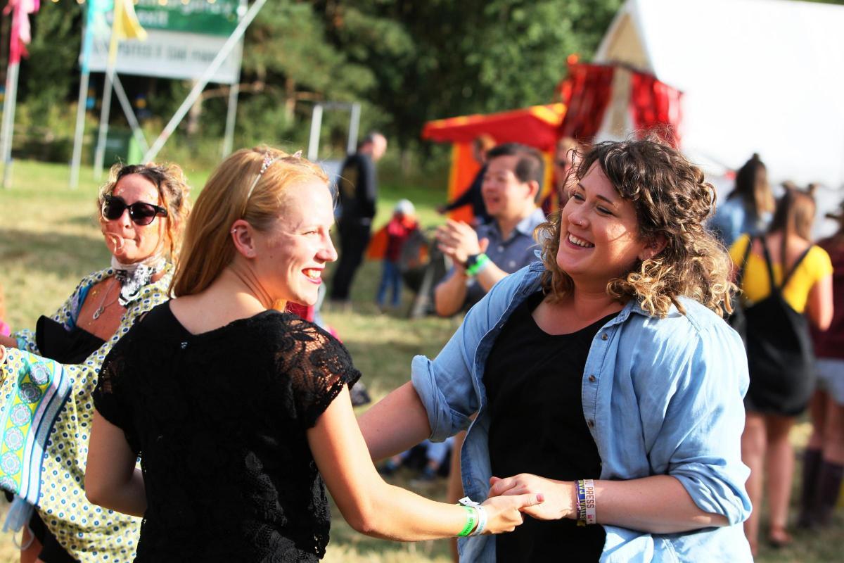 Friends enjoy a dance at the festival in 2018