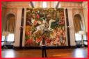 A visitor observes 'The Triumph of Death', Cecily Brown's largest painting to date (PA)