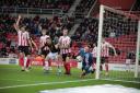 Gavin Whyte watches on as Sunderland goalkeeper Thorben Hoffman claws the ball away Picture: Darrell Fisher