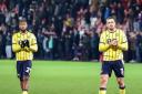 Kyle Edwards and Ciaron Brown applaud the Oxford United fans at the final whistle