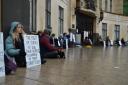 Protesters sat in silence outside the court.
