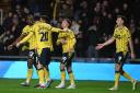 Oxford United players celebrate during the win against Wigan Athletic