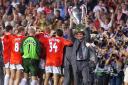 Manchester United’s suspended captain Roy Keane holds the trophy (Owen Humphreys/PA)