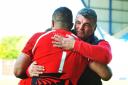 London Welsh head coach Rowland Phillips gives Eddie Aholelei a consoling hug after Saturday’s defeat
