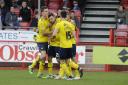 Chris Maguire is mobbed after scoring Oxford United's equaliser  Picture; David Fleming