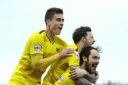 Danny Hylton, pictured celebrating a goal at AFC Wimbledon in February with fellow out-of-contract players Chris Maguire and Josh Ruffels, is one of nine Oxford United players who will find out their fate this week