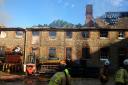 The blackened furniture workshop in Coleshill that was gripped by fire this morning